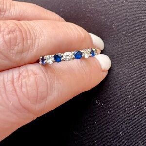 3.5 MM Sterling silver simulated diamond and sapphire band size 6. Not sizable.